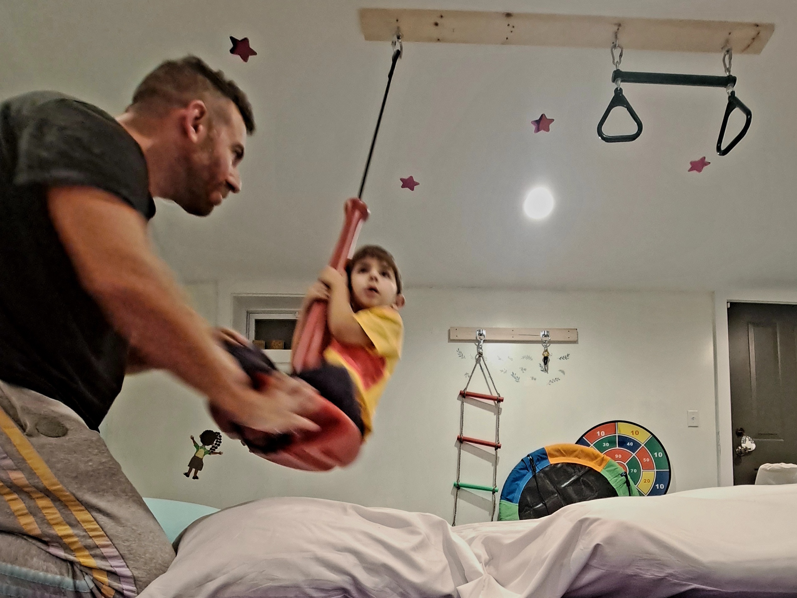 Sensory gym with hanging pod chair and foam mats