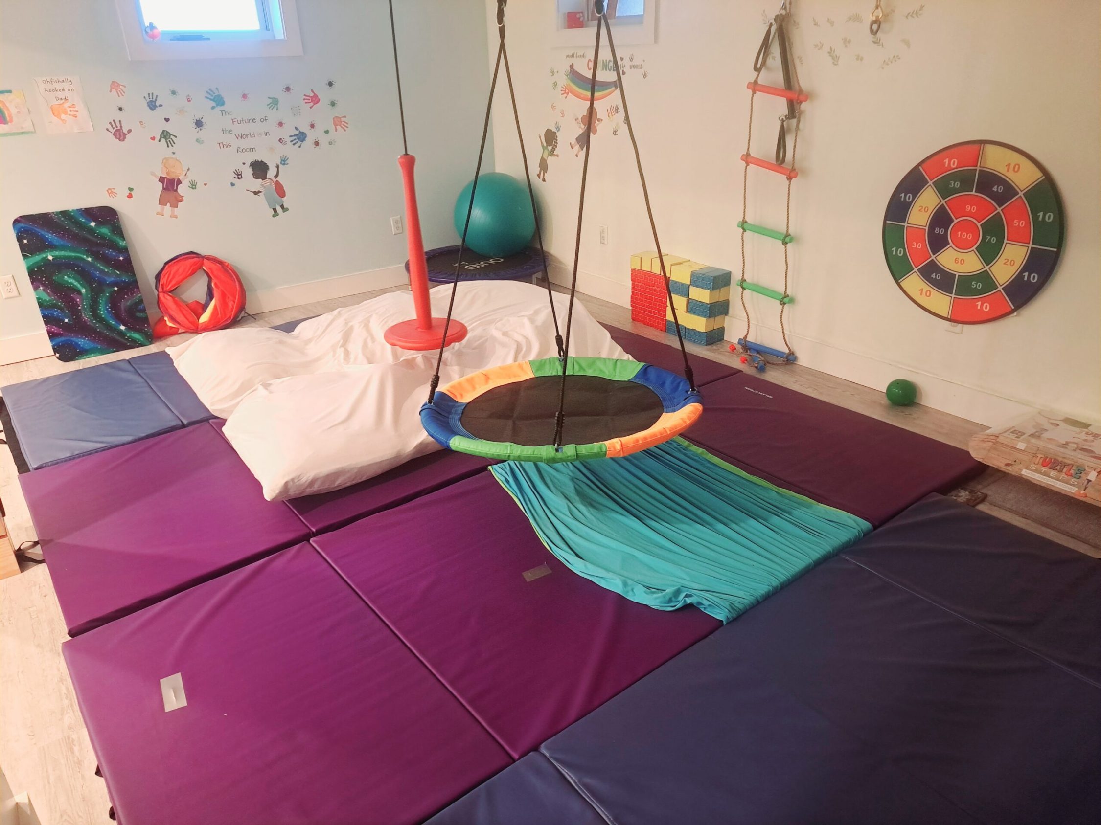 Indoor sensory play room with trampoline and foam equipment